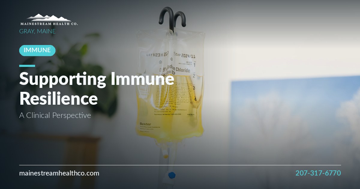IV therapy bag hanging in a bright, plant-filled clinical room