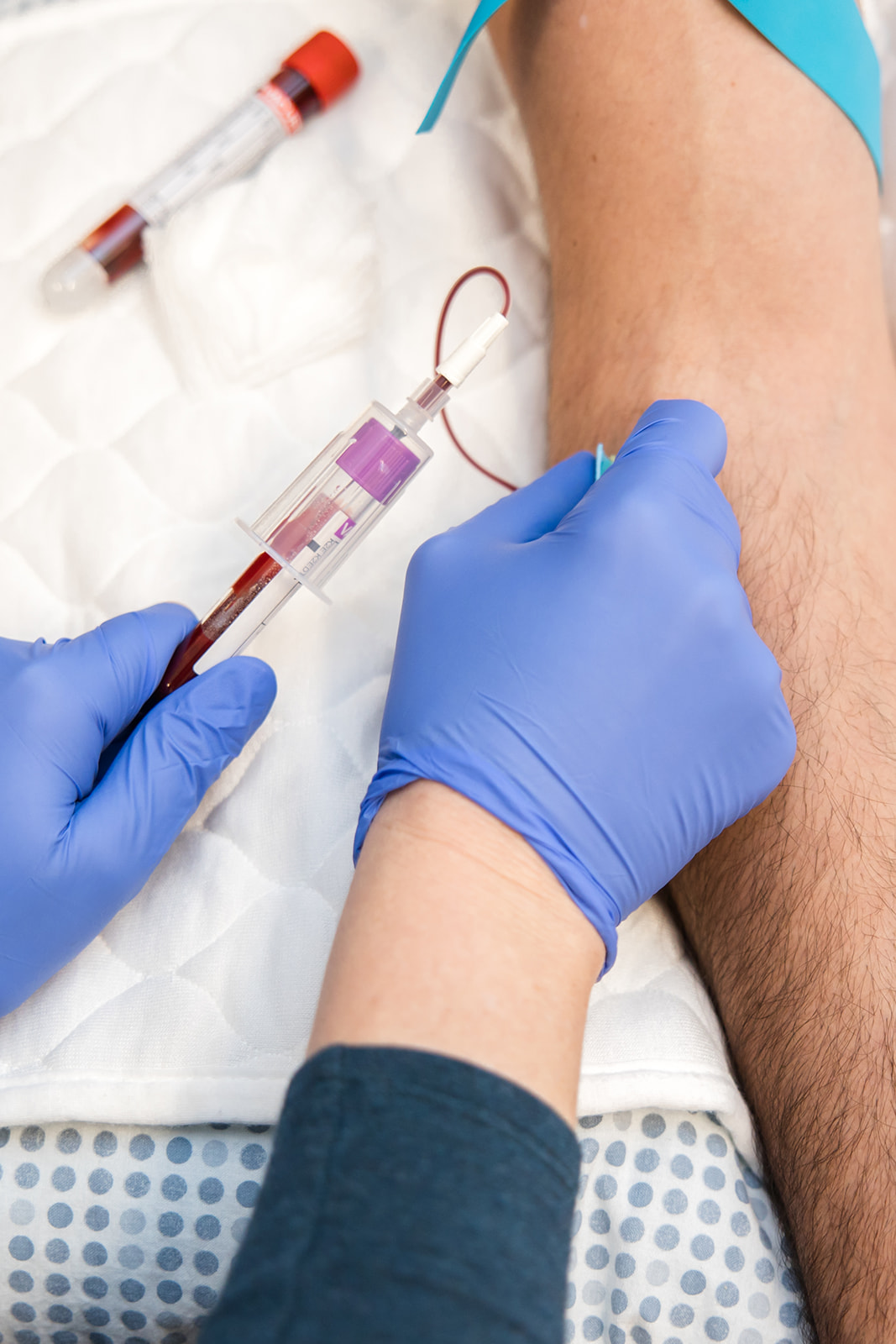 A gloved clinician performing an in-office blood draw at Mainestream Health Co.